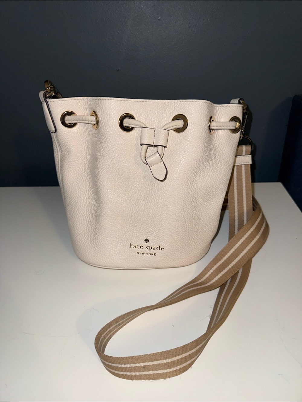 kate spade Cream Pebbled Leather Drawstring Bucket Bag with Striped Strap